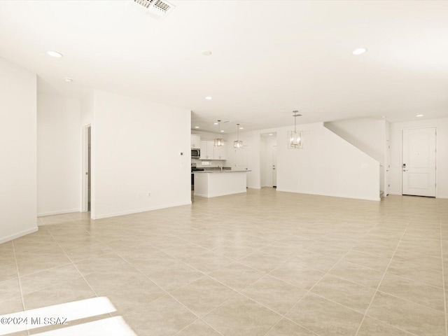 unfurnished living room featuring light tile patterned floors