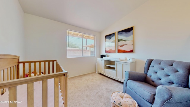 carpeted bedroom with vaulted ceiling and a crib