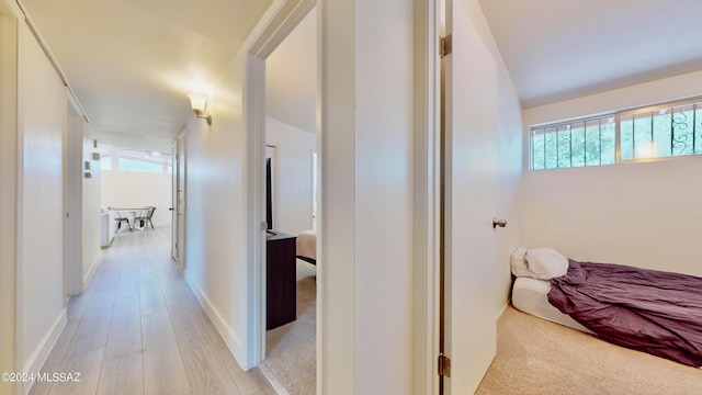 hallway with light hardwood / wood-style floors