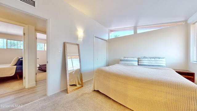 carpeted bedroom featuring vaulted ceiling