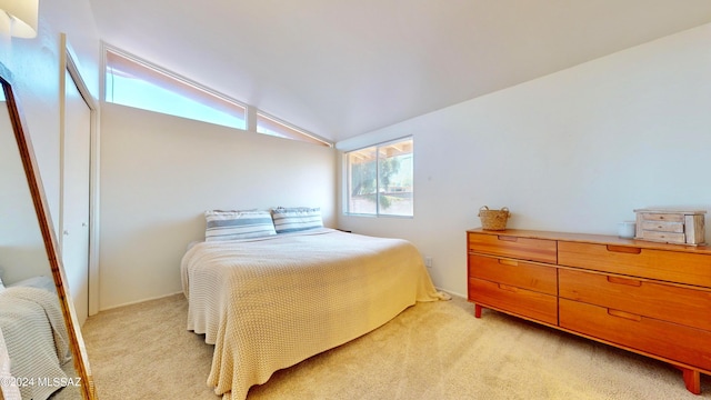 carpeted bedroom featuring lofted ceiling