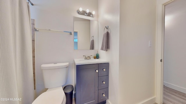 bathroom featuring hardwood / wood-style flooring, vanity, and toilet