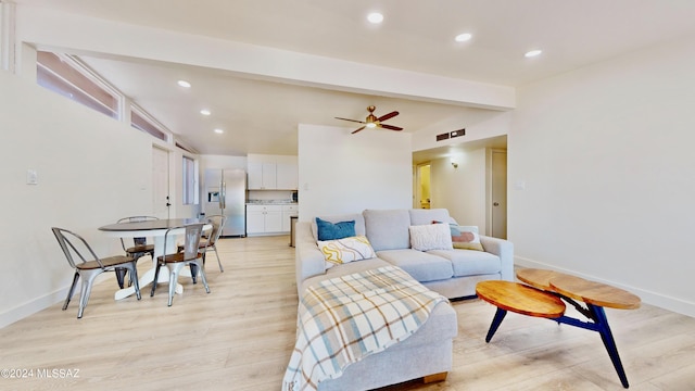 living room featuring vaulted ceiling with beams, ceiling fan, and light hardwood / wood-style flooring