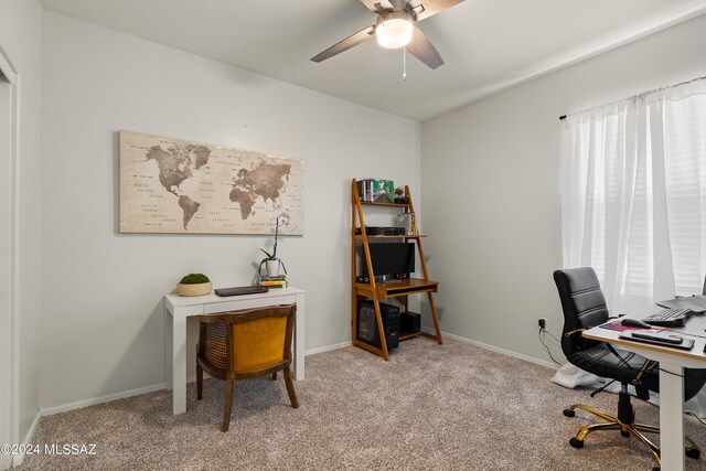 office area featuring light carpet and ceiling fan