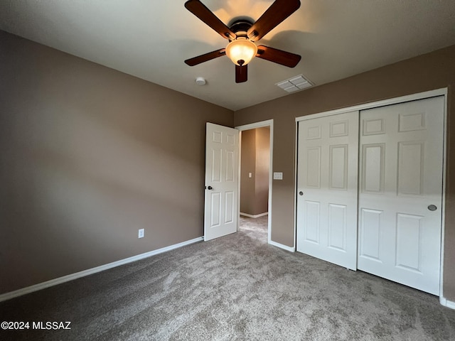 unfurnished bedroom featuring a ceiling fan, a closet, baseboards, carpet flooring, and visible vents