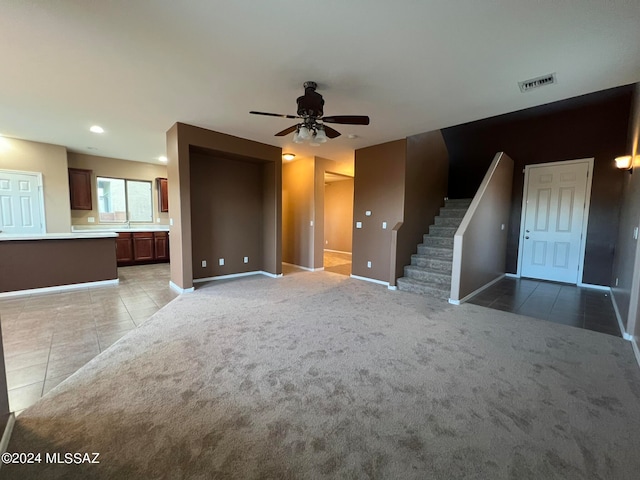 unfurnished living room with ceiling fan and light tile patterned floors