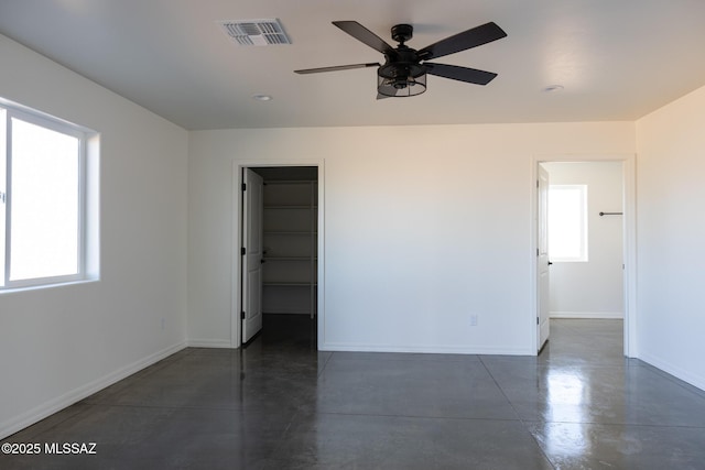 unfurnished room featuring ceiling fan and a healthy amount of sunlight