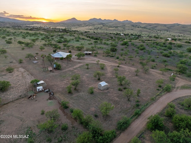 aerial view at dusk featuring a mountain view