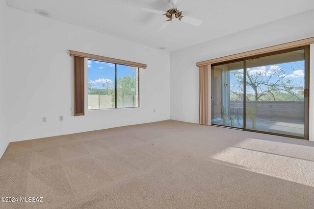 hall with light colored carpet and a textured ceiling