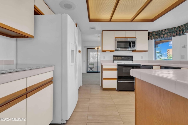 kitchen featuring white cabinetry, electric range, light tile patterned floors, and white refrigerator with ice dispenser