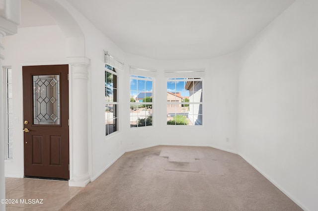 foyer with light colored carpet