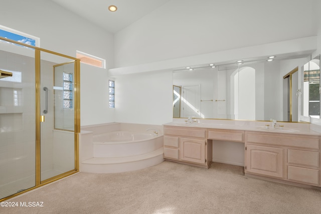 bathroom with high vaulted ceiling, separate shower and tub, and vanity