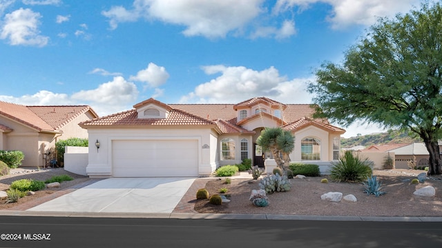 mediterranean / spanish-style house with a garage