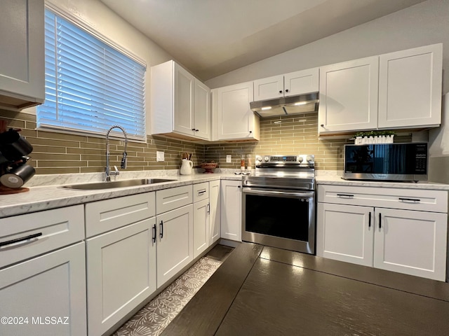 kitchen with appliances with stainless steel finishes, sink, backsplash, light stone countertops, and white cabinetry