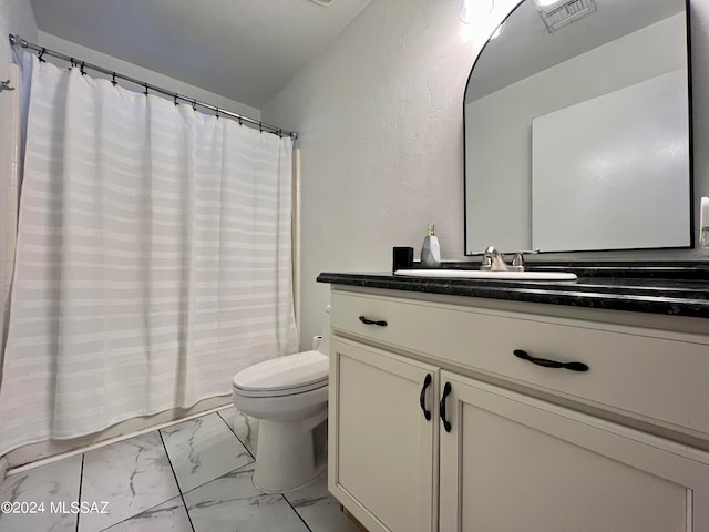 bathroom with tile patterned floors, vanity, and toilet