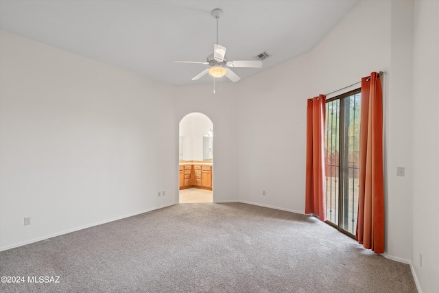 empty room featuring high vaulted ceiling, ceiling fan, and carpet flooring