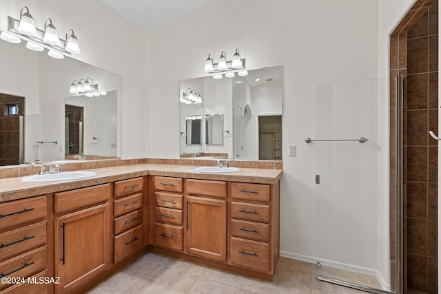 bathroom featuring an enclosed shower, tile patterned flooring, and vanity