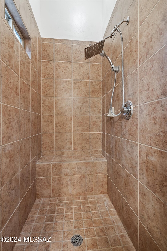 bathroom with a tile shower