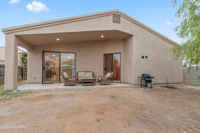 rear view of house featuring a patio and outdoor lounge area