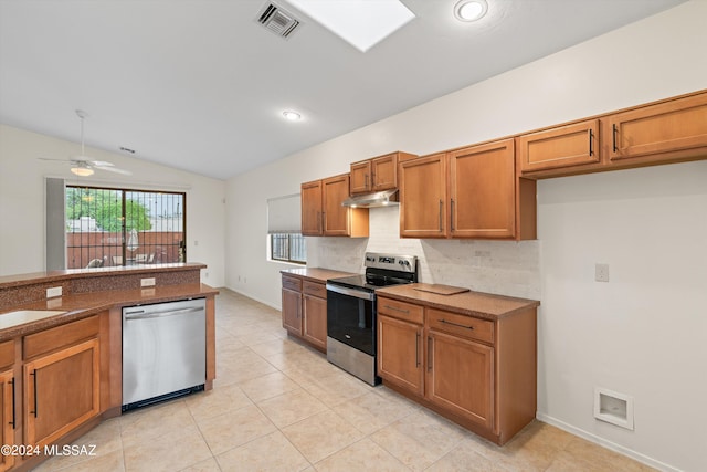 kitchen featuring tasteful backsplash, stainless steel appliances, lofted ceiling, ceiling fan, and light tile patterned floors