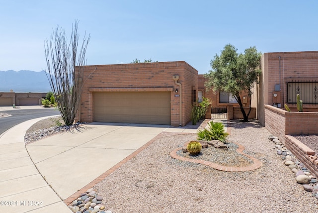 view of front of property with a garage and a mountain view