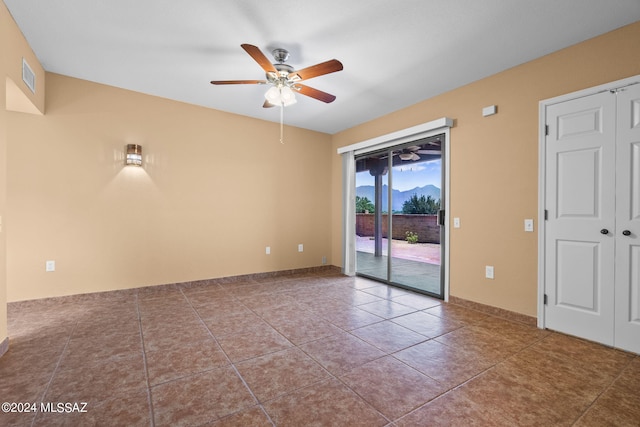 tiled empty room with ceiling fan