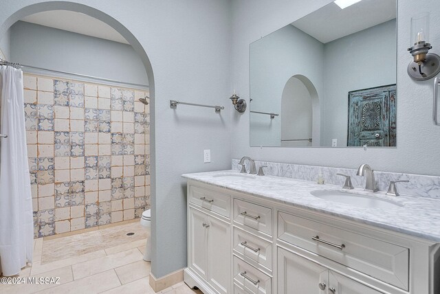 bathroom with toilet, vanity, a shower with curtain, and tile patterned flooring