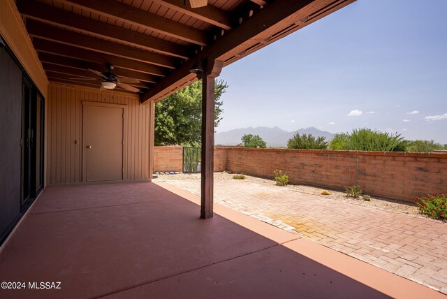 view of patio / terrace featuring a mountain view and ceiling fan