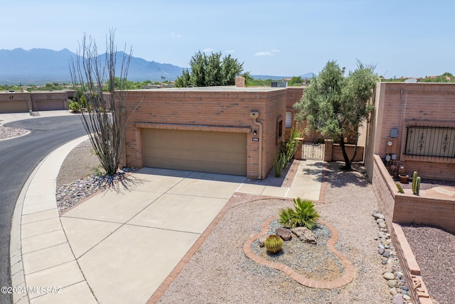 view of front facade featuring a garage and a mountain view