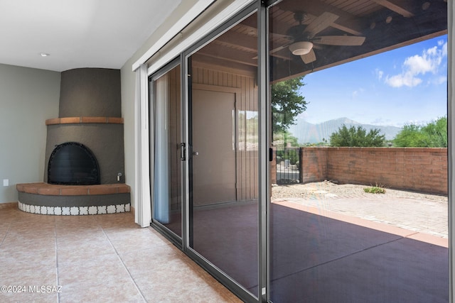 view of patio featuring a mountain view and ceiling fan