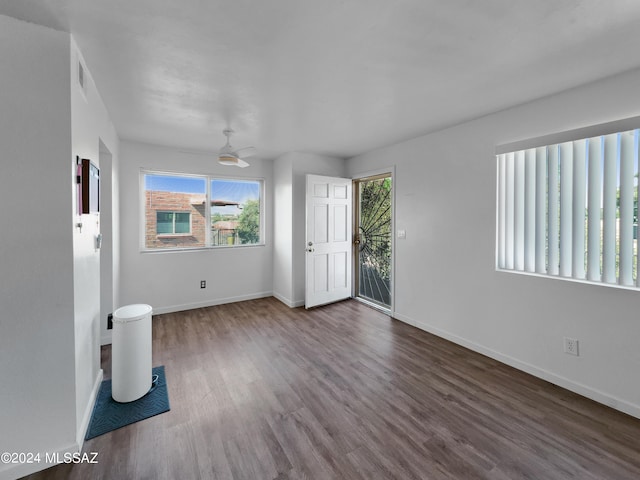 unfurnished room with dark hardwood / wood-style floors and ceiling fan