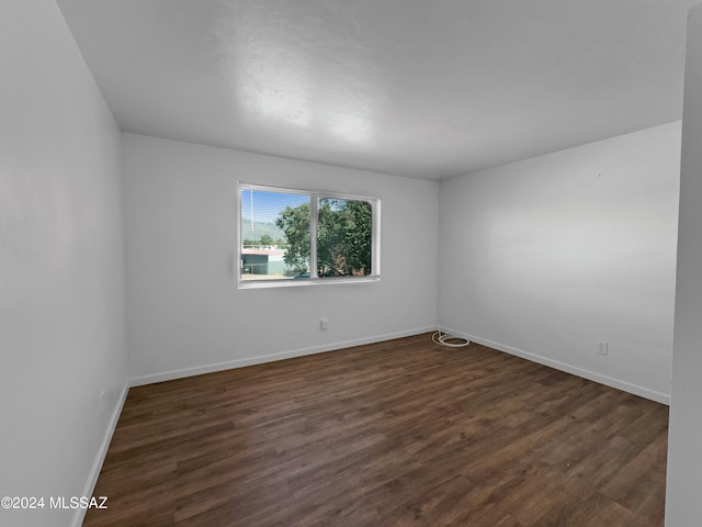 empty room featuring dark wood-type flooring