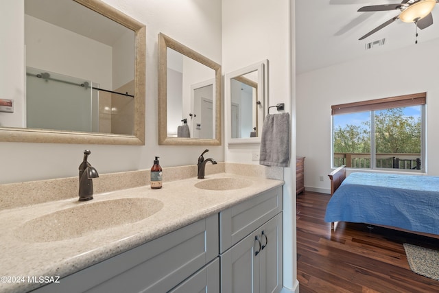 bathroom with ceiling fan, dual vanity, and wood-type flooring