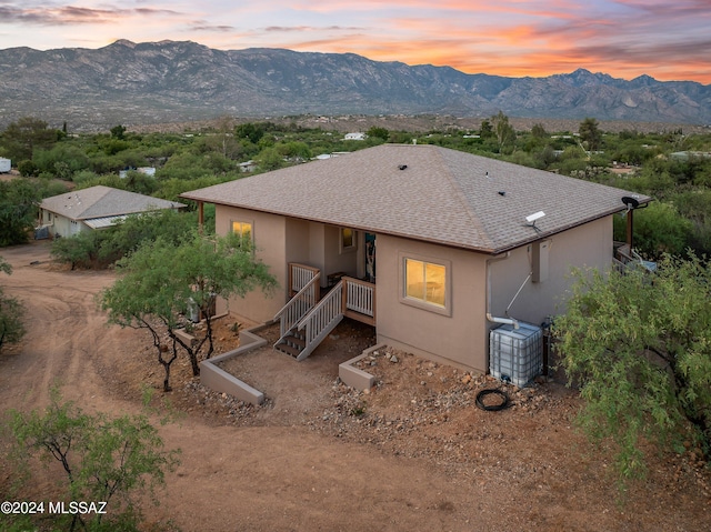 back house at dusk featuring a mountain view