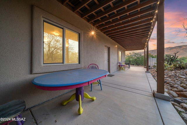 view of patio terrace at dusk