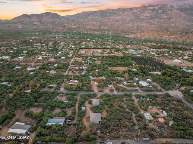 aerial view at dusk featuring a mountain view