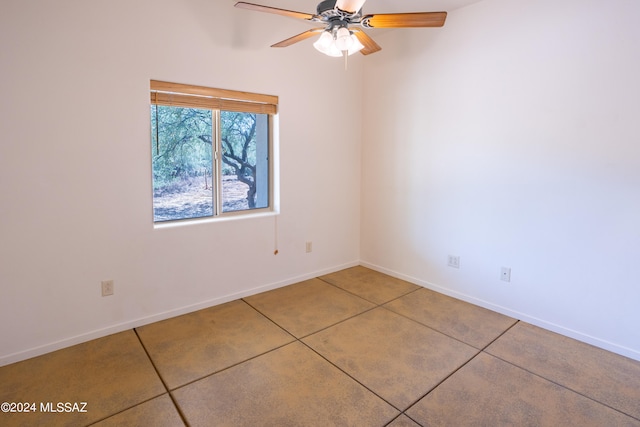 tiled empty room with ceiling fan