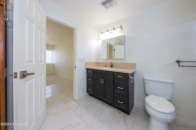 bathroom featuring toilet and vanity