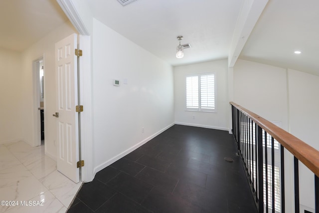 hall featuring beamed ceiling