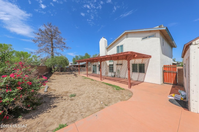 back of property with a patio