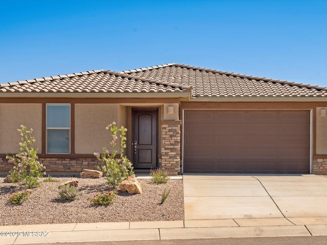 350 N Pecan Canyon Ln, Sahuarita, AZ 85629 - view of front of property featuring stone siding, concrete driveway, stucco siding, an attached garage, and a tiled roof