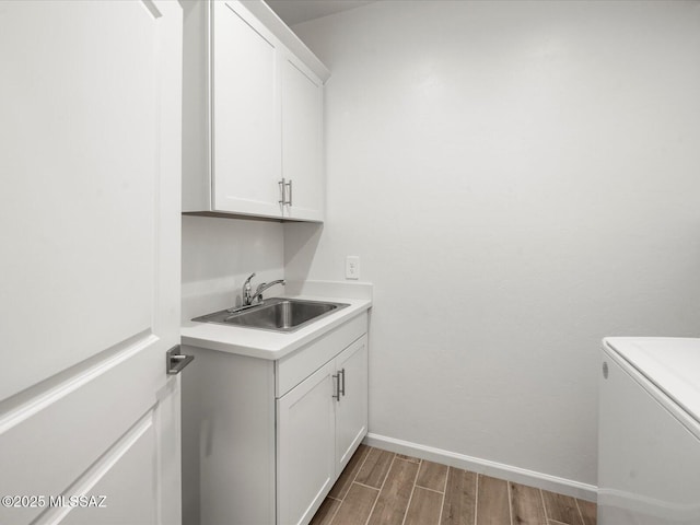 350 N Pecan Canyon Ln, Sahuarita, AZ 85629 - laundry area with wood finished floors, baseboards, and cabinet space