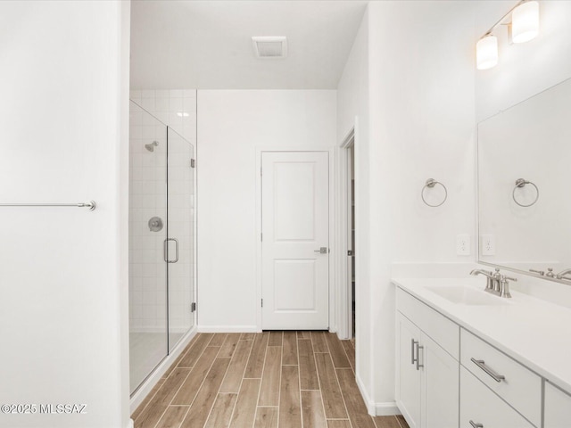 350 N Pecan Canyon Ln, Sahuarita, AZ 85629 - bathroom with vanity, a shower stall, wood finished floors, and baseboards