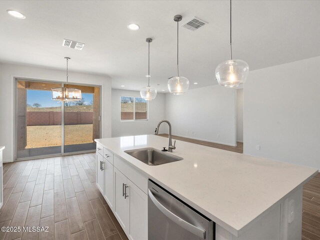350 N Pecan Canyon Ln, Sahuarita, AZ 85629 - kitchen with dishwasher, a sink, wood finished floors, recessed lighting, and white cabinets