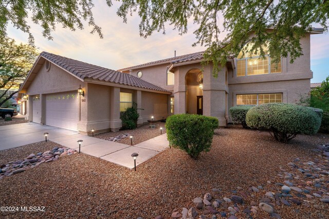 mediterranean / spanish home featuring a garage