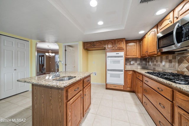 kitchen featuring sink, double oven, black gas stovetop, and light tile patterned flooring