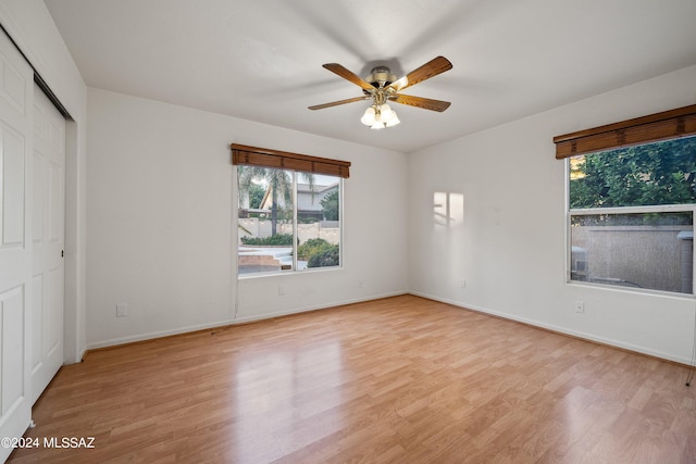 unfurnished bedroom featuring light hardwood / wood-style flooring, a closet, and ceiling fan