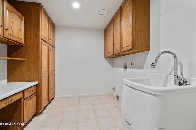 clothes washing area featuring hookup for an electric dryer, hookup for a gas dryer, cabinets, hookup for a washing machine, and light tile patterned floors