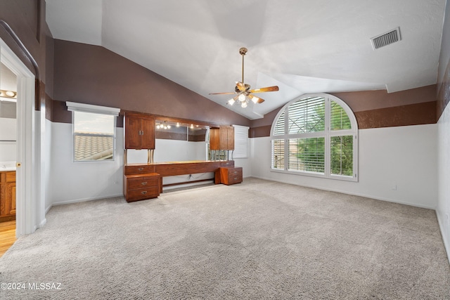 unfurnished living room featuring light carpet, high vaulted ceiling, and ceiling fan