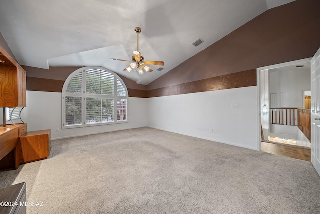 living room with light carpet, ceiling fan, and vaulted ceiling